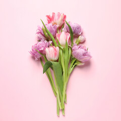 Beautiful colorful tulip flowers on pink background, top view