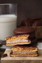 Tasty choco pies on wooden board, closeup. Space for text