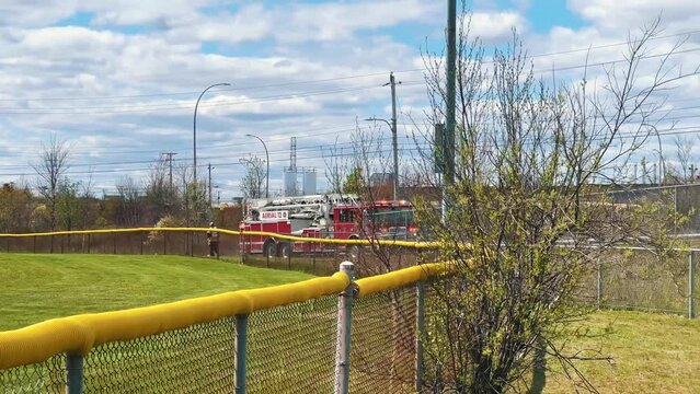 Fire Truck With a Siren and Flashing Lights Drives at High Speed to Save the Lives of 911 People. FDNY EMS Firefighters Drive to the Scene With Flashing Lights Outside. Canada, Dartmouth