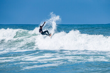 Surfer riding waves in Furadouro Beach