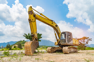 Heavy earth mover with blue sky in the background