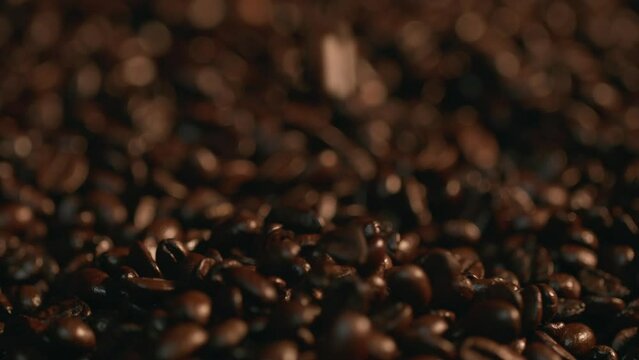 Coffee Beans Falling in a Pile of Coffee Beans, Slow Motion. Shot with ARRI Alexa in ArriRaw at 120 fps and exported 23.98 fps, QuickTime Apple ProRes 422 HQ.