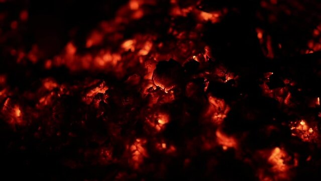 Burning coal, fire and charcoal closeup with campfire hot embers and dark ash. Night orange flame and inferno outdoor with smoke, burn and fireplace dust at bonfire with warm heat for camping