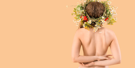 Beautiful naked young woman in flower wreath on beige background with space for text, back view....