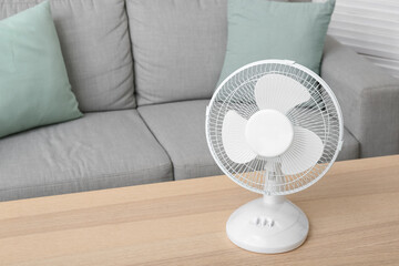 Modern electric fan on table in living room