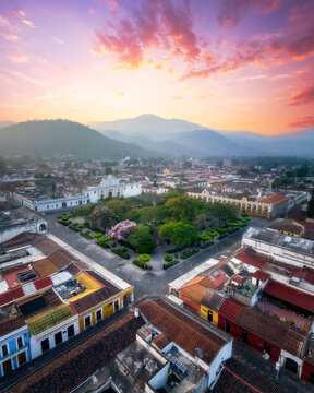 Aerial drone view of Antigua, Guatemala town square central plaza at sunrise - beautiful brightly colored popular Central American town for tourism