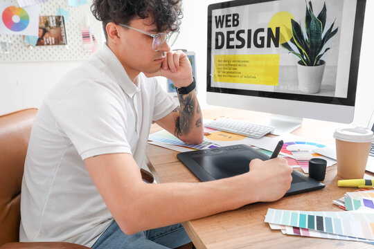 Male graphic designer working with tablet in office