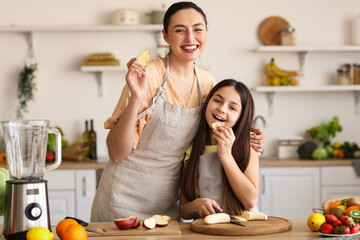 Little girl with her mother eating fruits while making smoothie in kitchen