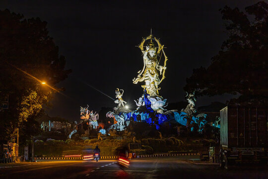 Denpasar, Bali, Indonesia  The iconic large statue of Titi Banda at an intersection at night.