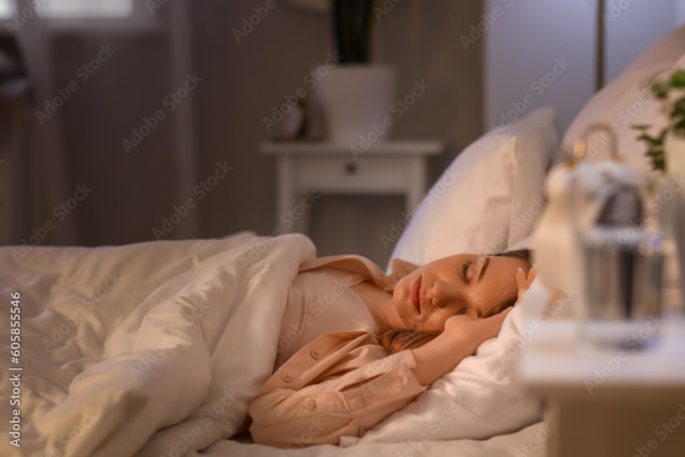 Sticker Young woman sleeping in bed at night