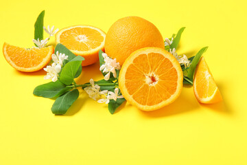 Blooming branches with oranges on yellow background