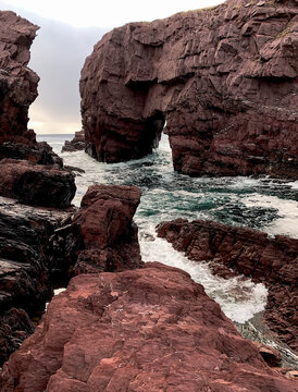 Rocky Coastal Sea Arch with Waves and Rugged Cliffs