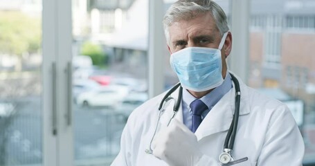 Surgery mask, gloves and senior doctor ready to start healthcare and wellness work in clinic. Hospital, elderly man and male professional with safety gear for support and care for health job