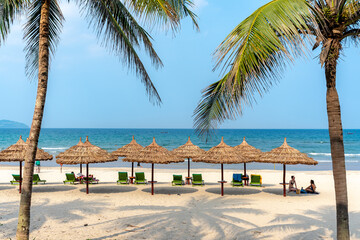 Umbrellas for tourists on the white sand beach at Da Nang city beach, Quang Nam Province, Vietnam