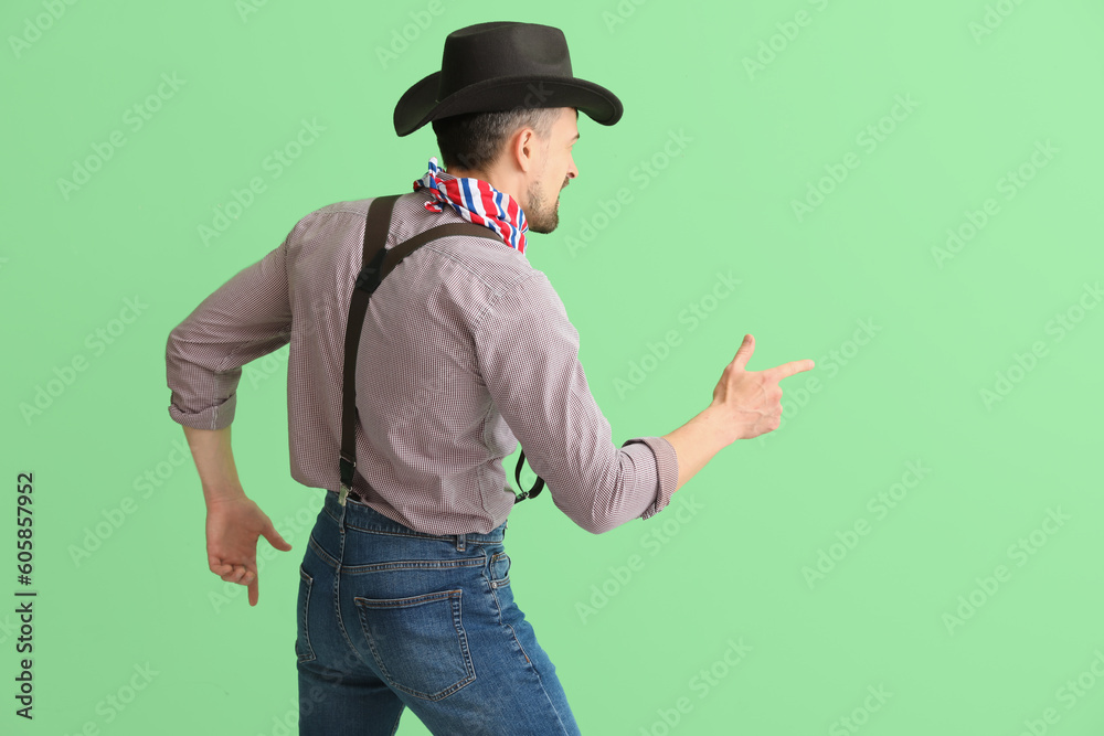 Poster Handsome cowboy on green background