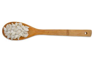 Pumpkin seeds lie in a wooden spoon isolated on a transparent background.