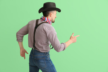 Handsome cowboy on green background