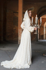 Naklejka premium Woman in dress with candles