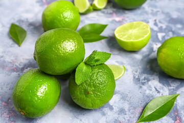 Fresh limes with leaves on blue background