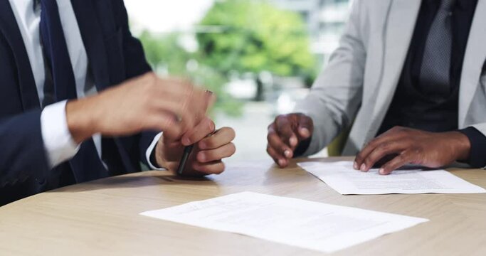 Business people, signature and shaking hands for contract, agreement and partnership in office. Closeup, employees and handshake for signing legal documents, hiring deal and opportunity on paperwork