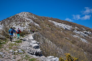 Rear view of people hiking in karst landscape in Croatia