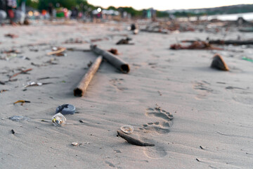 Mountains of waste and garbage on the sandy beach after the tide. Humanity is polluting the ocean