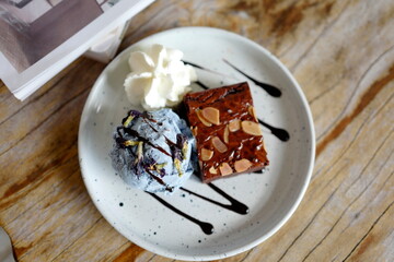 Brownie and ice cream is a classic dessert combination that brings together the irresistible flavors and textures of a warm, chocolatey brownie and a cold, creamy scoop of ice cream. 