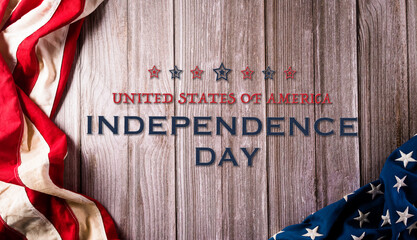 4th of July happy Independence day concept. Vintage American flag and the text on old wooden background.
