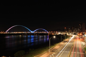 Fototapeta na wymiar Night view of train tracks at Crescent Bridge, Banqiao District, New Taipei City, Taiwan