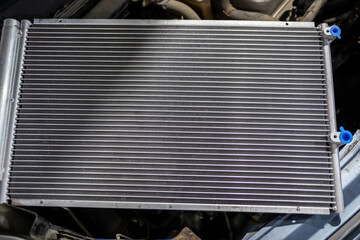 Texture of a car radiator. Engine cooler background. Vintage style. Radiator grille for car interior heater air conditioner, close-up. Radiator repair and replacement.