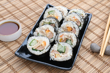 Korean Rolled Gimbap, made of rice, cucumber, tuna, carrot, sausage, crab stick and wrapped with seaweed laver. 
