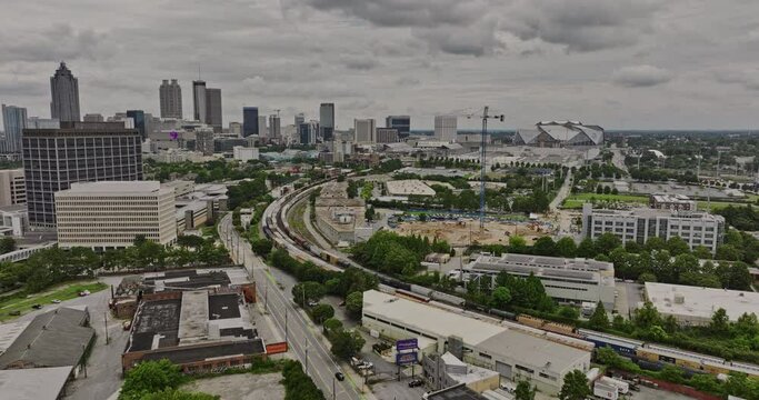 Atlanta Georgia Aerial v855 establishing drone flyover Marietta St NW towards Centennial Park District with moving train leading to downtown cityscape - Shot with Mavic 3 Cine - August 2022