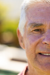 Half portrait of happy senior caucasian man looking at camera and smiling in sunny garden
