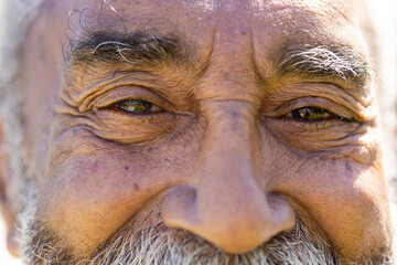 Portrait close up of happy senior biracial man looking at camera and smiling in sun