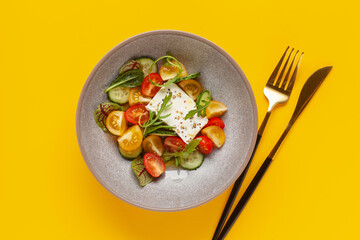 Easy greek salad of fresh cucumber, tomato, arugula,  feta cheese  with olive oil. Healthy food. Top view