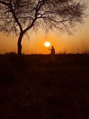 silhouette of a person walking on a sunset