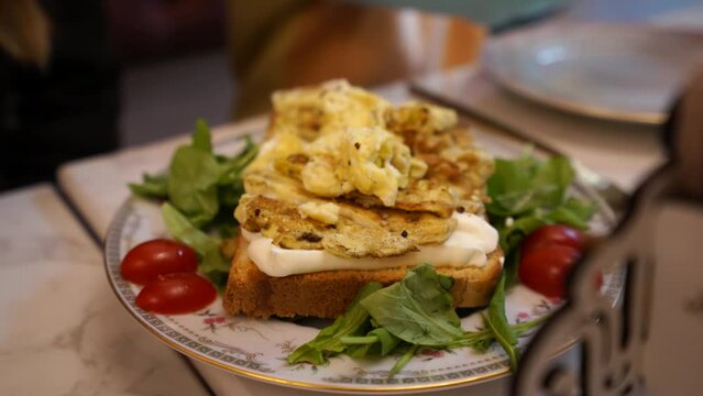 Healthy breakfast egg toast served with tomato, vegetables, cream cheese and white bread