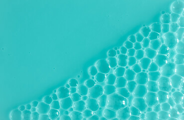 Bubble mint turquoise background texture. Berry gel to cleanse the skin of the face and body. Spa treatments, skin care. Bath foam, detergent. Slime blue