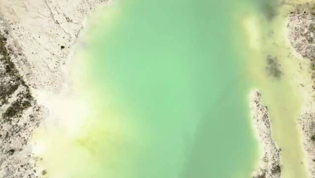 Top down shot of a turquoise lake surrounded by a kaolin mine