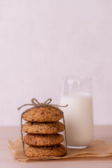 Oatmeal cookies with milk on a wooden background