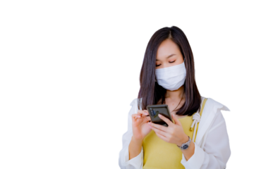 Young Asian woman wearing face mask while using mobile phone