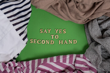 SAY YES TO SECOND HAND text on clothes assortment Second hand sustainable shopping. Capsule minimal...