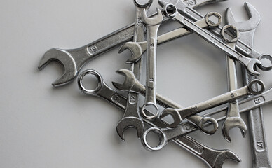 Arranged in the straight geometric shape variety ring wrenches, box end spanners and hex wrenches and on white surface