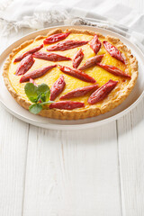 Homemade cake with custard and rhubarb close-up in a plate on the table. Vertical