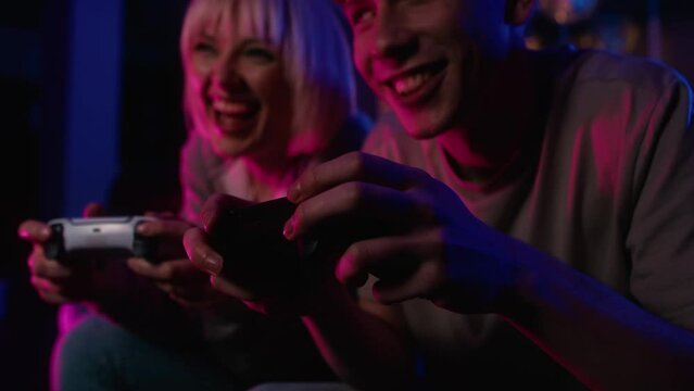 Detail of young caucasian couple playing video game with game pads. Shot with RED helium camera in 8K