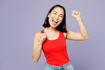 Young woman of Asian ethnicity she wear casual clothes red tank shirt doing winner gesture...