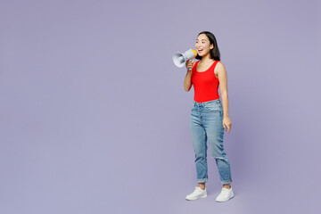 Full body young woman of Asian ethnicity she wear casual clothes red tank shirt hold in hand megaphone scream announces discounts sale Hurry up isolated on plain pastel light purple background studio.