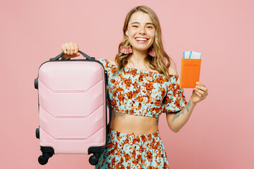 Traveler woman wear summer casual clothes hold passport boarding ticket bag isolated on plain pink background. Tourist travel abroad in free spare time rest getaway. Air flight trip journey concept.
