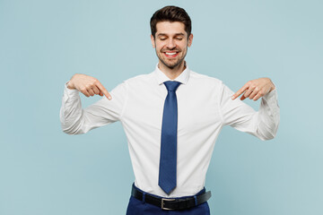 Young employee business man corporate lawyer wearing classic formal shirt tie work in office point index finger down on workspace area mock up isolated on plain pastel blue background studio portrait.