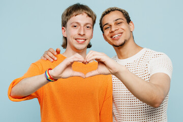 Young couple two gay men wear casual clothes together showing shape heart with hands heart-shape...